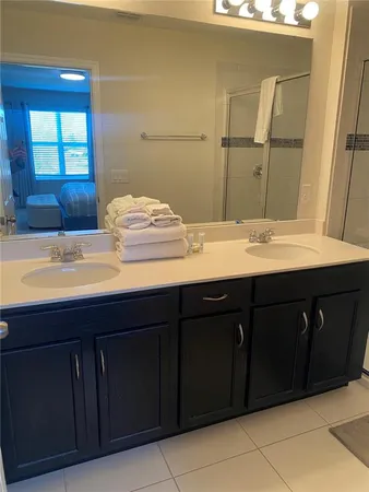a bathroom with a sink vanity and mirror
