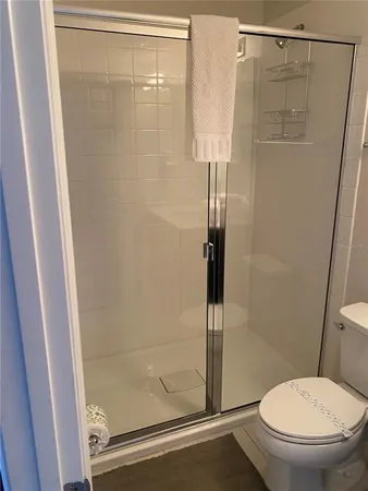 a bathroom with a shower a toilet and a sink