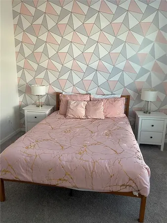 a bedroom with a bed and a mirror