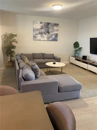 a living room with furniture and a potted plant