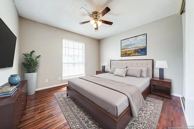 a bedroom with bed and a potted plant