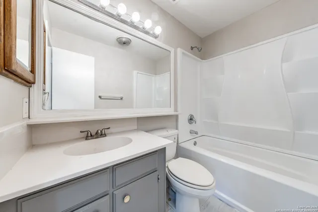 a bathroom with a sink a toilet and a bathtub