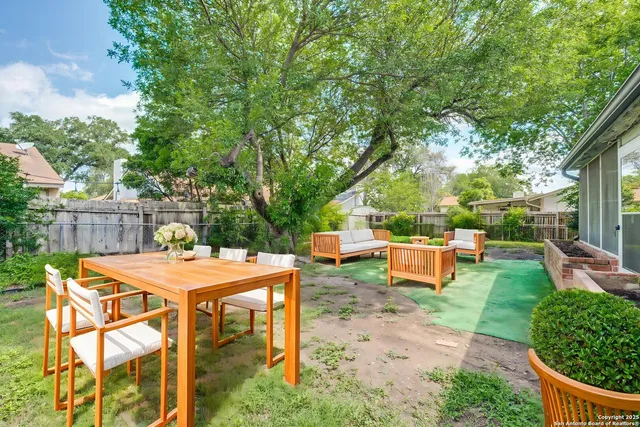 a view of a backyard with sitting area