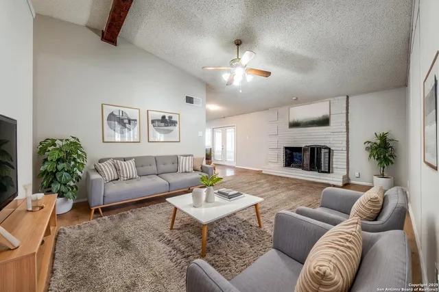 a living room with furniture and a fireplace