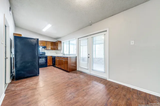 a large kitchen with a refrigerator and a sink