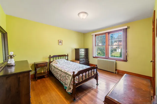 a bedroom with a bed and a window