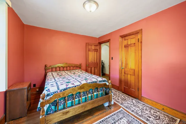 a room with wooden floor and a window