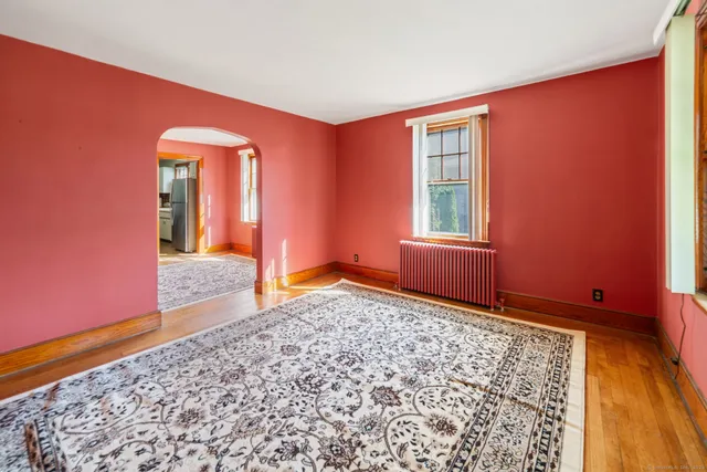 a bedroom with bed and wooden floor