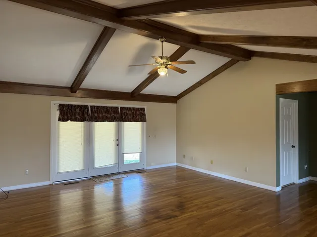 a large kitchen with wooden cabinets and a sink