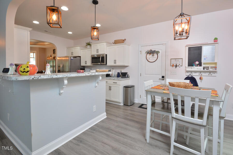 195 Timberwind Road Franklinton, NC 27525 - Photo 11 of 28 a kitchen with stainless steel appliances kitchen island a refrigerator and a stove top oven