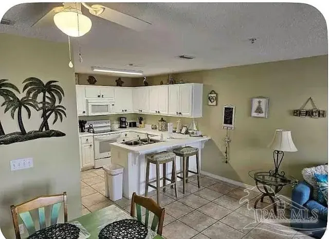 a kitchen with a sink appliances and cabinets