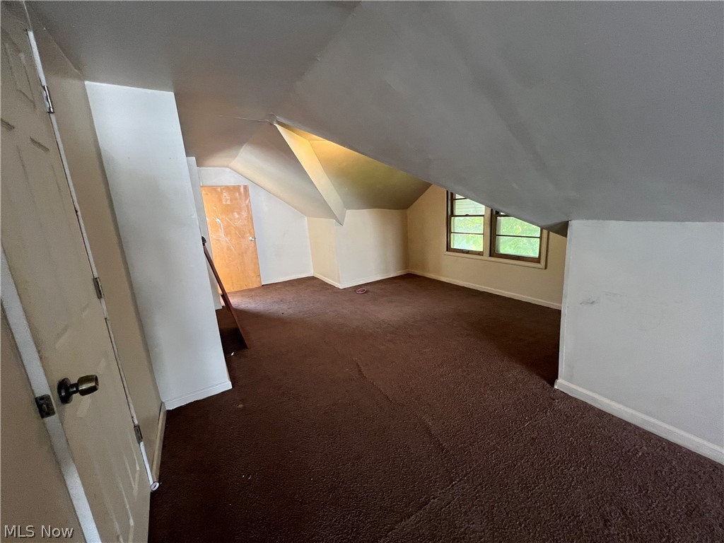 20731 Donnybrook Road Maple Heights, OH 44137 - Photo 11 of 17 Additional living space with carpet and vaulted ceiling