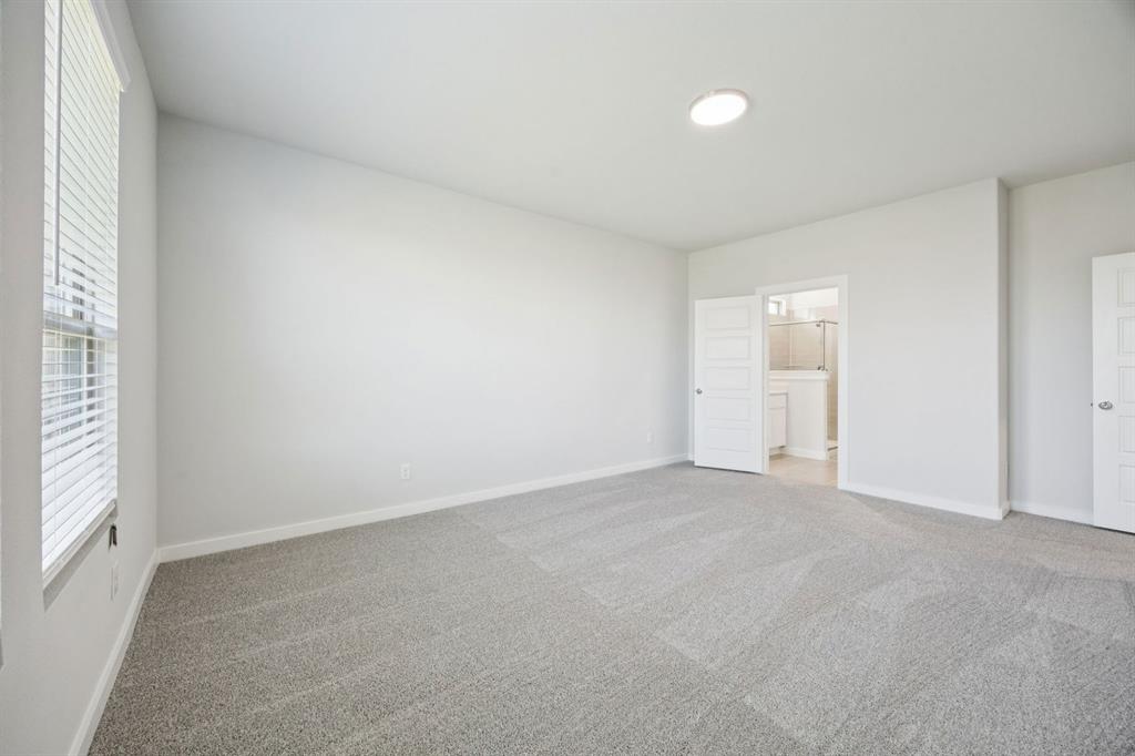 9521 Rattlesnake Trail Crowley, TX 76036 - Photo 18 of 35 an empty room with windows and refrigerator in it