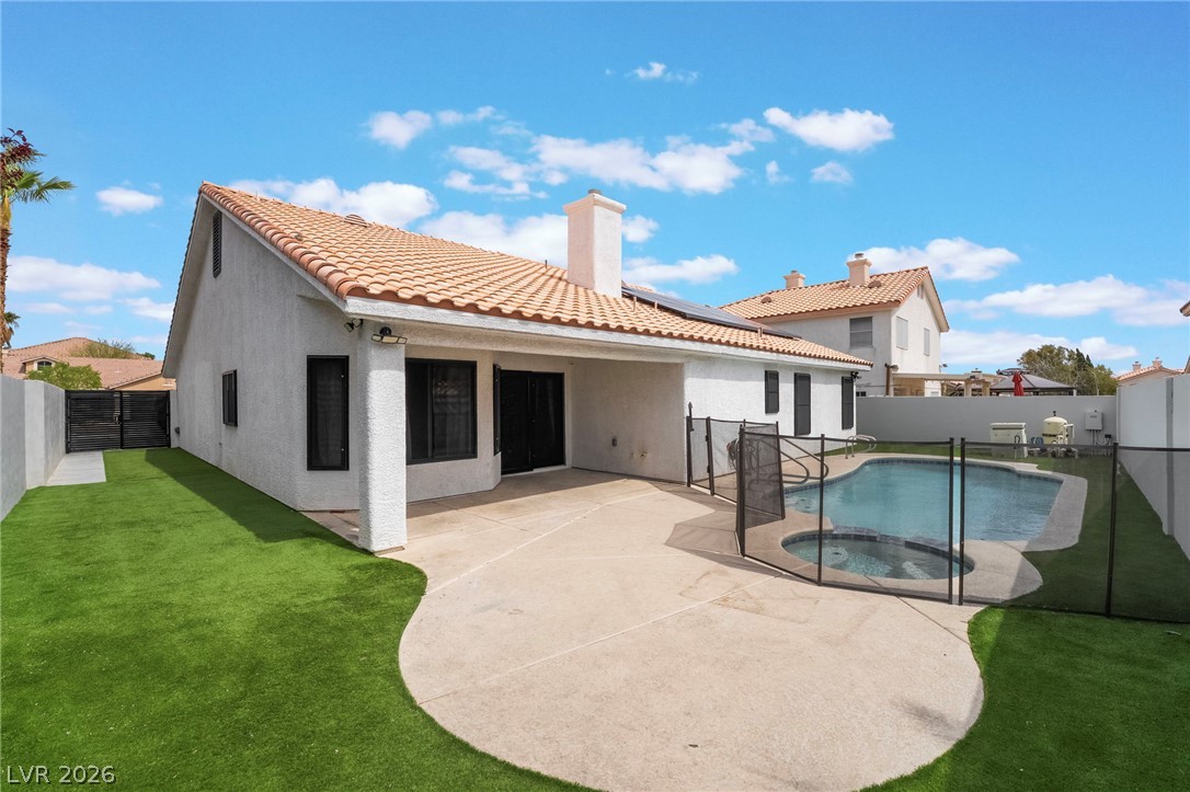 9171 West Viking Road Las Vegas, NV 89147 - Photo 38 of 43 A well-maintained pool and spa are enclosed within a private fenced yard with a concrete patio.