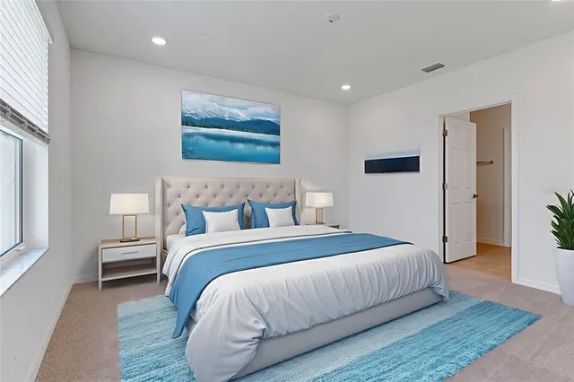 a bedroom with a bed and a painting