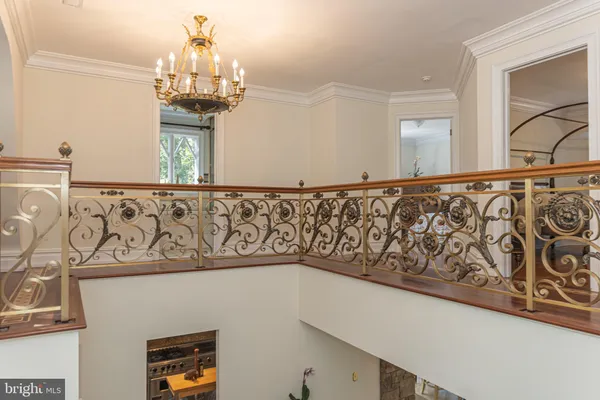a room with chandelier fan and windows