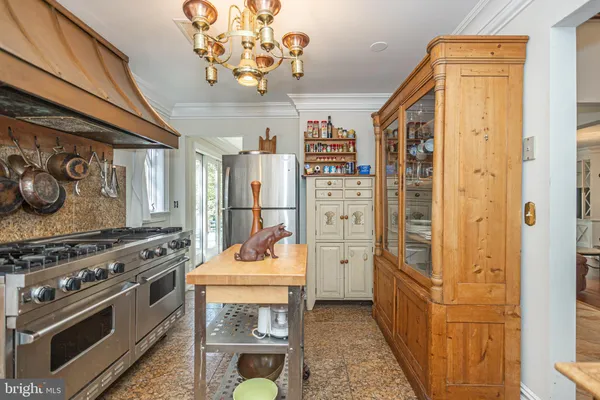 a kitchen with a stove a sink and a refrigerator