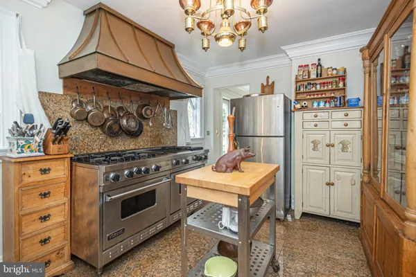 a stove top oven sitting inside of a kitchen
