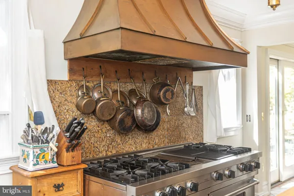 a bedroom with a bed chandelier and a fireplace