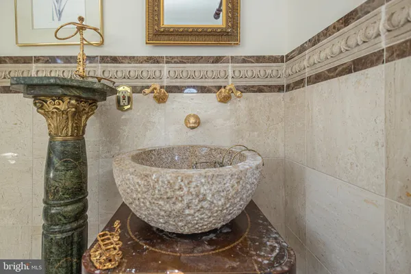 a bathroom with a tub sink and mirror