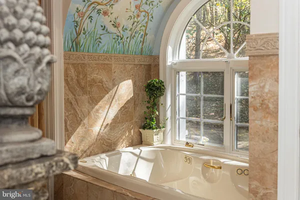 a view of a house with a fountain and a table and chairs