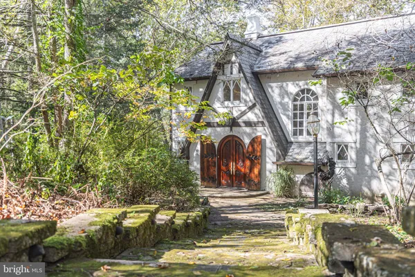 a view of a small house with a tree in the yard