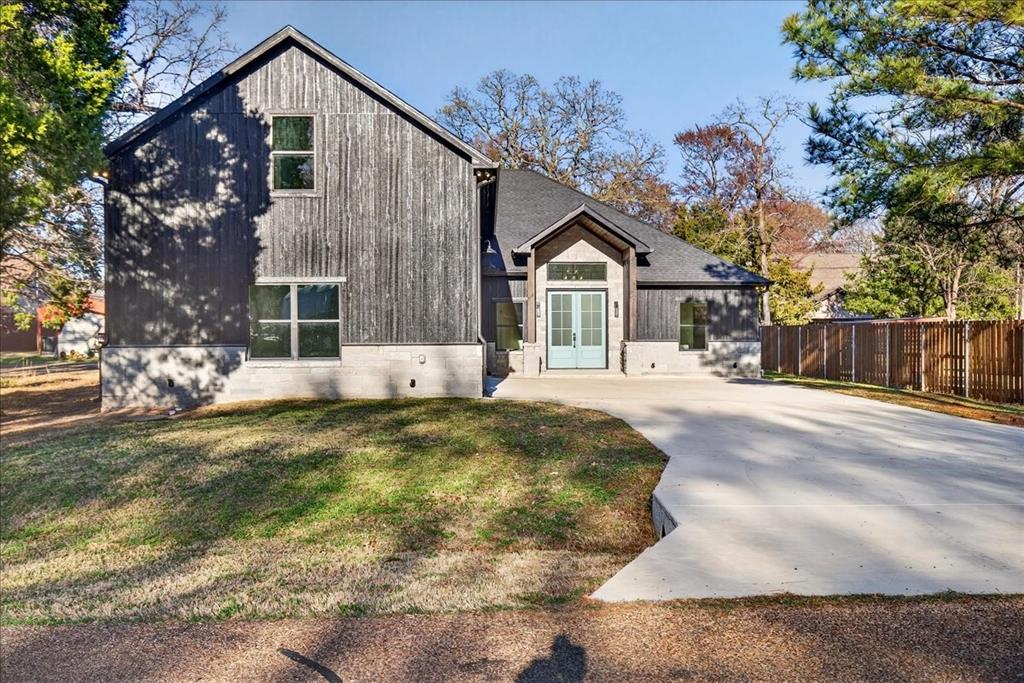 114 Castlewood Road Enchanted Oaks, TX 75156 - Photo 32 of 33 a front view of a house with a yard covered with snow and trees