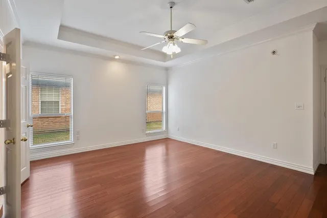a view of empty room with wooden floor and fireplace