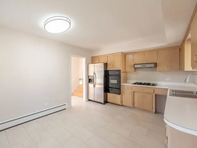 a large kitchen with cabinets and stainless steel appliances