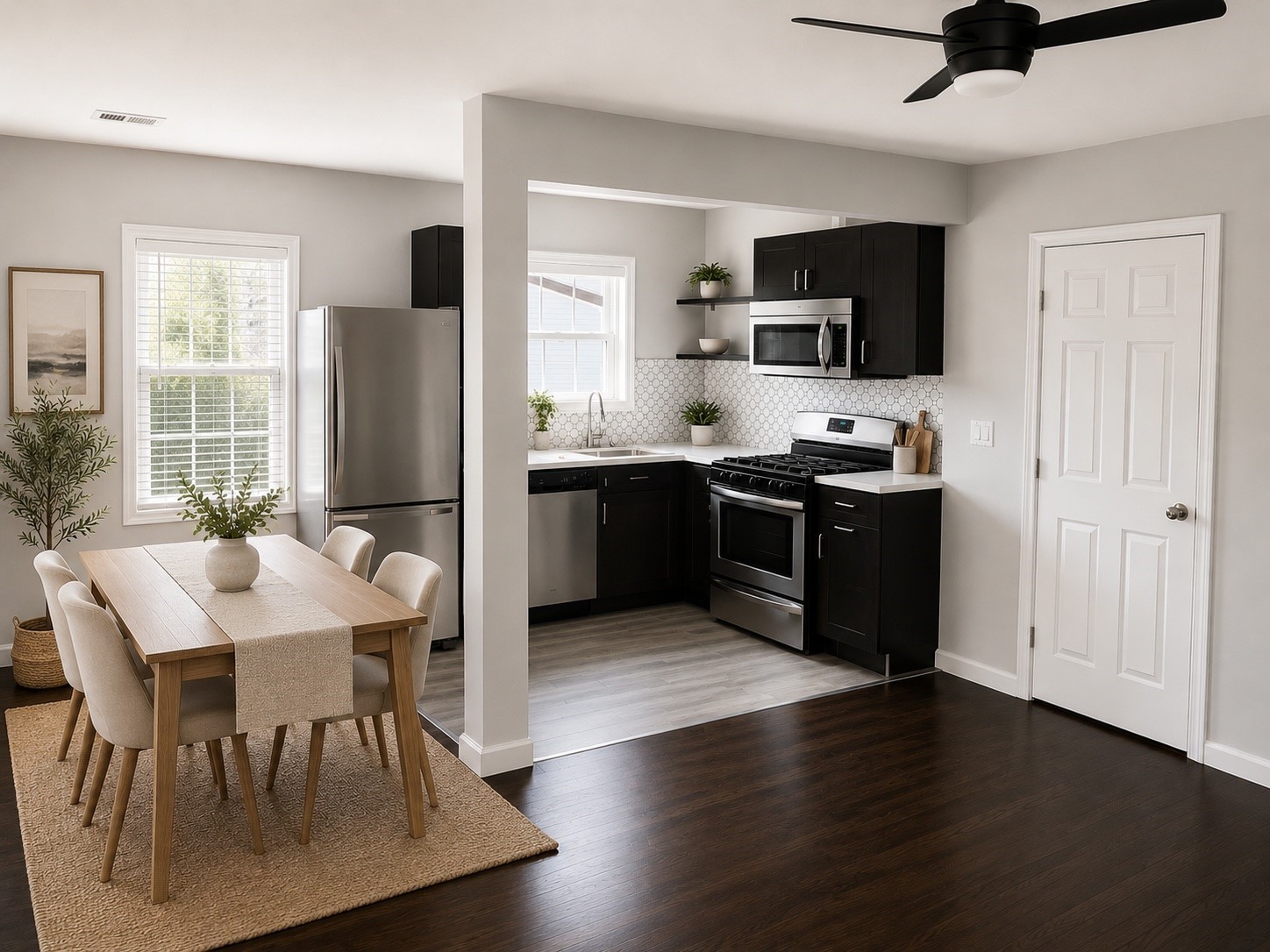 1825 1/2 Santa Rosa Street Houston, TX 77023 - Photo 7 of 7 a kitchen with stainless steel appliances granite countertop a stove a refrigerator a microwave a dining table and chairs with wooden floor