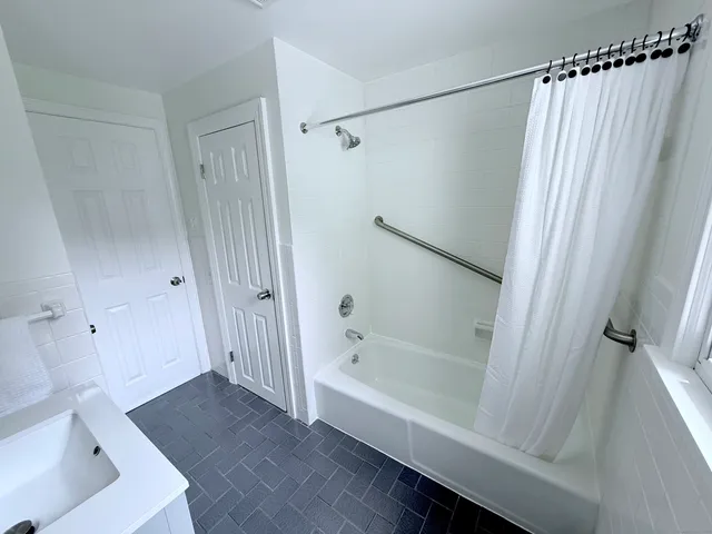 a bathroom with a bathtub and a shower