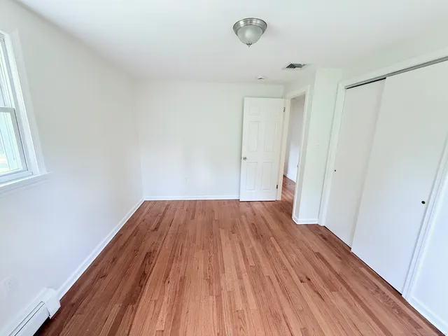 a view of a room with wooden floor