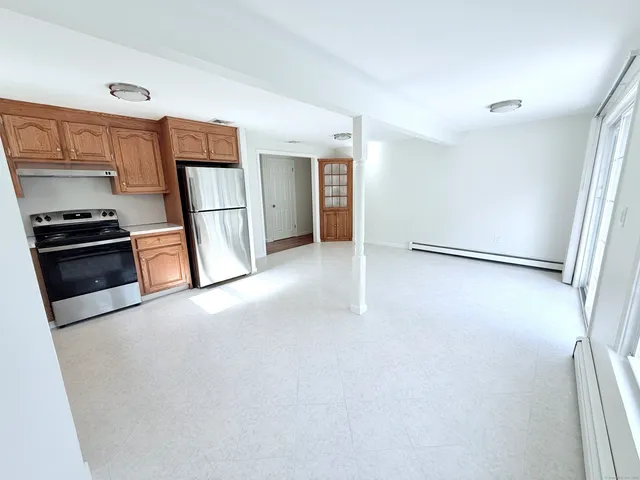 a kitchen with a refrigerator and a stove