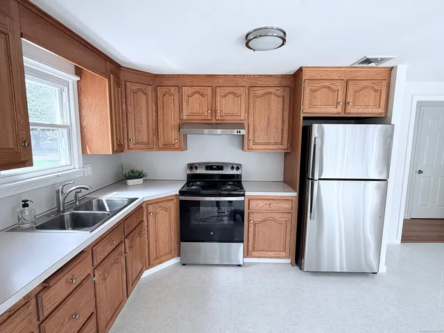 a kitchen with a refrigerator stove and sink
