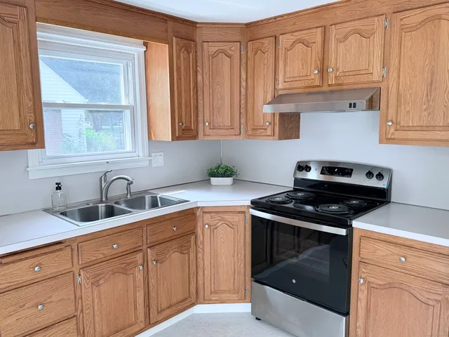 a kitchen with granite countertop a sink and cabinets