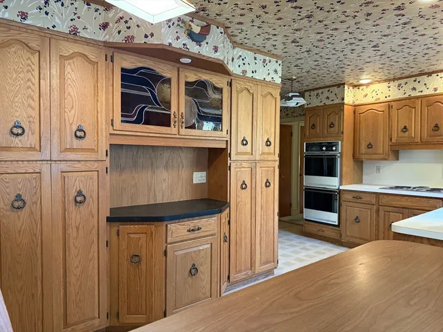 a kitchen with granite countertop a refrigerator and a stove