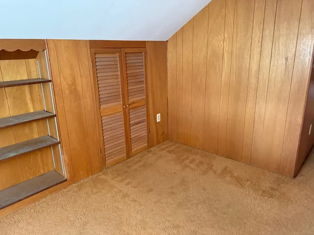 an empty room with closet area