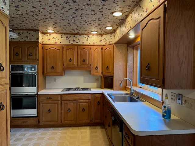 a kitchen with a sink appliances and cabinets