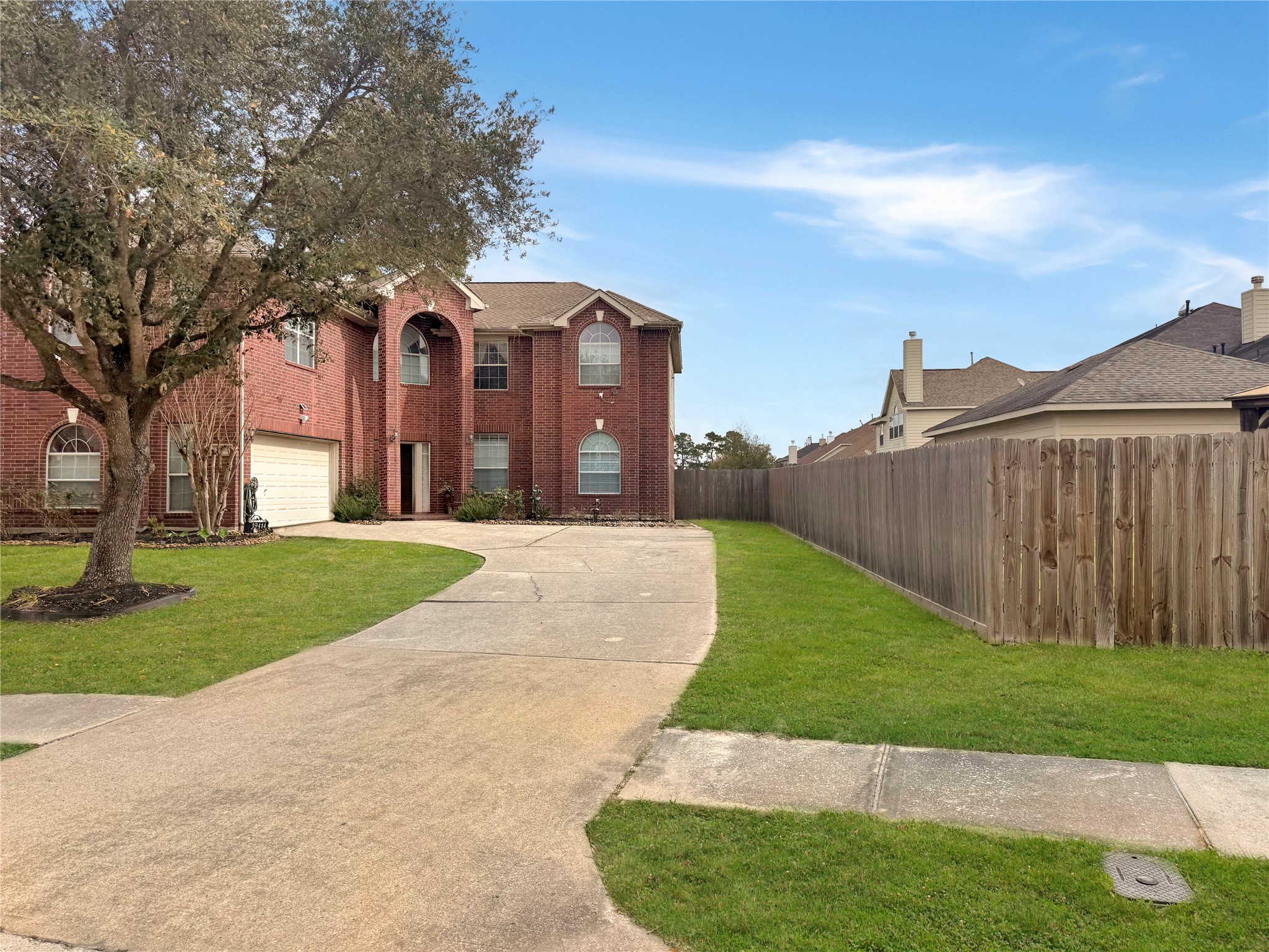 19414 Countryroad Dr Spring Spring, TX 77388 - Photo 5 of 8 a view of a white house with a big yard and large tree