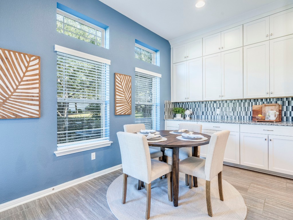 2930 Grand Oaks Loop, Unit 1903 Cedar Park, TX 78613 - Photo 12 of 36 a view of a dining room with furniture and wooden floor
