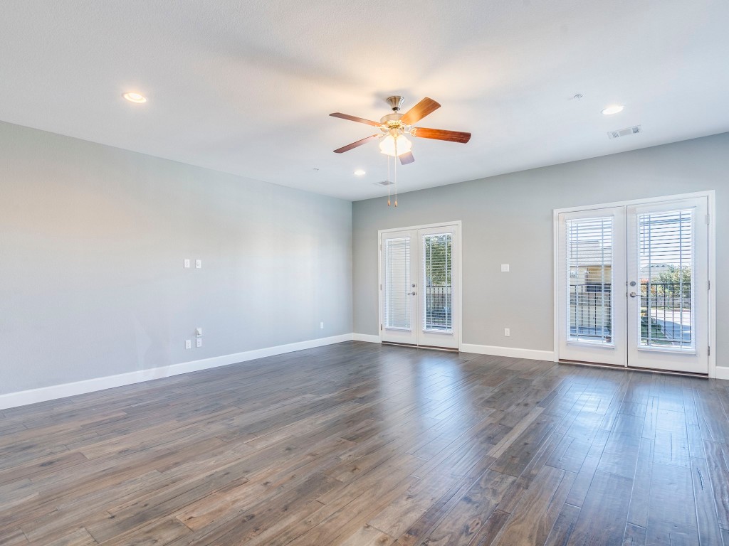 2930 Grand Oaks Loop, Unit 1903 Cedar Park, TX 78613 - Photo 18 of 36 a view of an empty room with wooden floor and a window