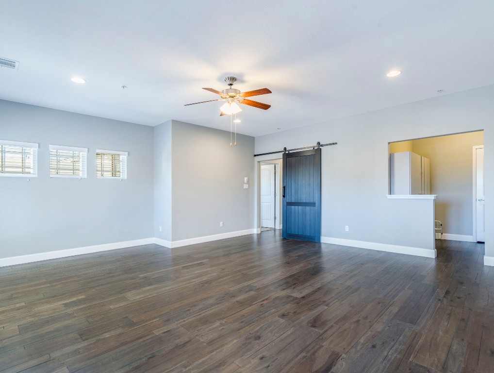 2930 Grand Oaks Loop, Unit 1903 Cedar Park, TX 78613 - Photo 19 of 36 a view of an empty room with window and wooden floor
