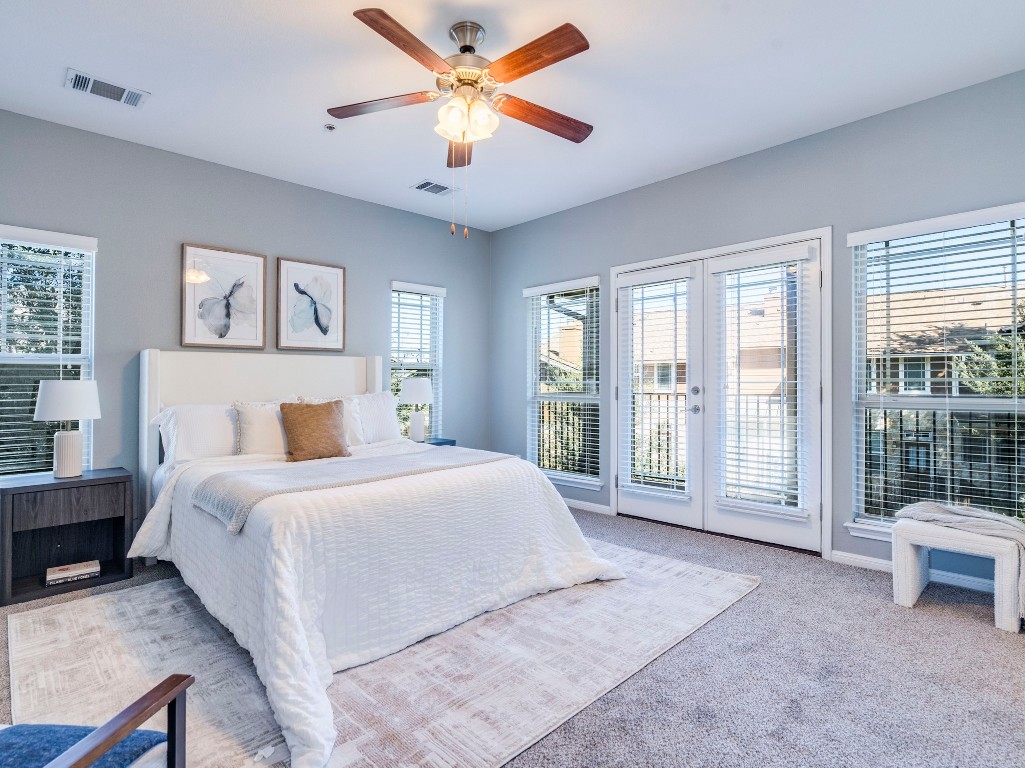 2930 Grand Oaks Loop, Unit 1903 Cedar Park, TX 78613 - Photo 21 of 36 a spacious bedroom with a large bed and a large window