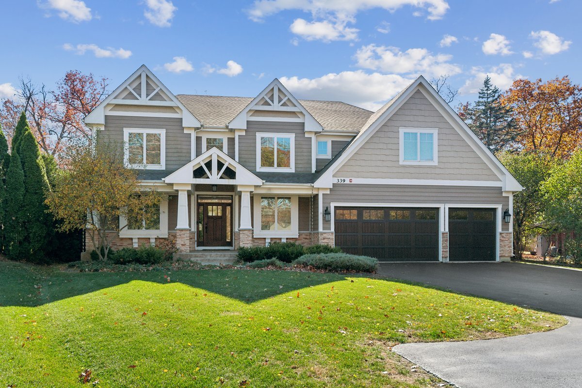Undisclosed Address Lake Bluff, IL 60044 - Photo 1 of 5 a front view of a house with a yard and garage
