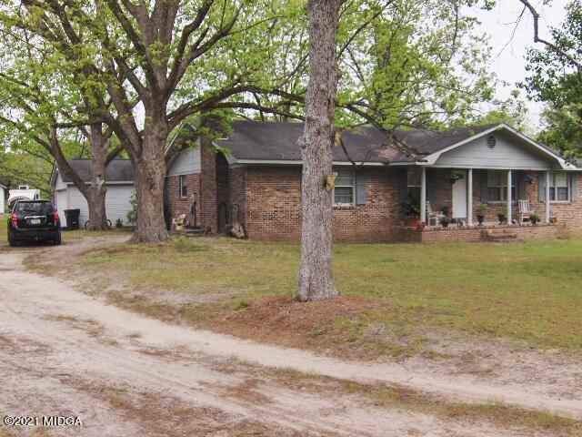 7152 Goodall Mill Road Macon, GA 31216 - Photo 1 of 25 a front view of a house with a yard and large trees