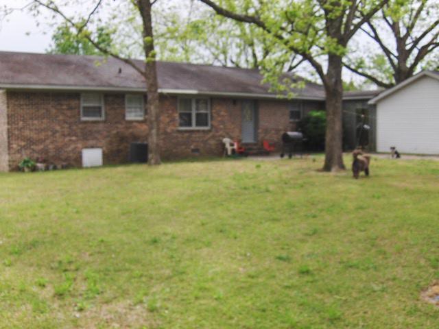 7152 Goodall Mill Road Macon, GA 31216 - Photo 9 of 25 a brick house with a yard plants and large tree