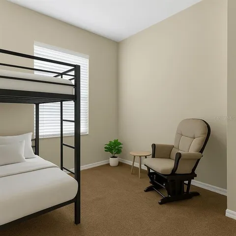 a bedroom with a bed and a potted plant