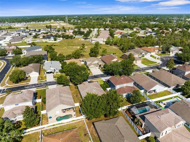 an aerial view of residential houses with outdoor space