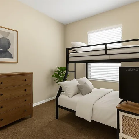 a bedroom with a bed and a potted plant