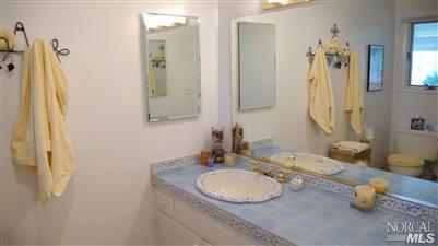 4190 Big Ranch Road Napa, CA 94558 - Photo 10 of 10 a bathroom with a granite countertop sink and a mirror